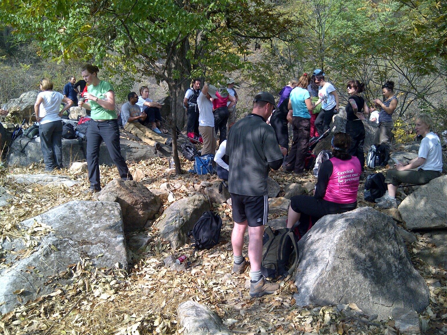 The trekking group resting among rocks and woodland